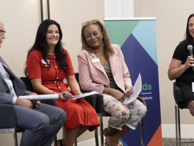 Image of panelist speakers laughing with each other